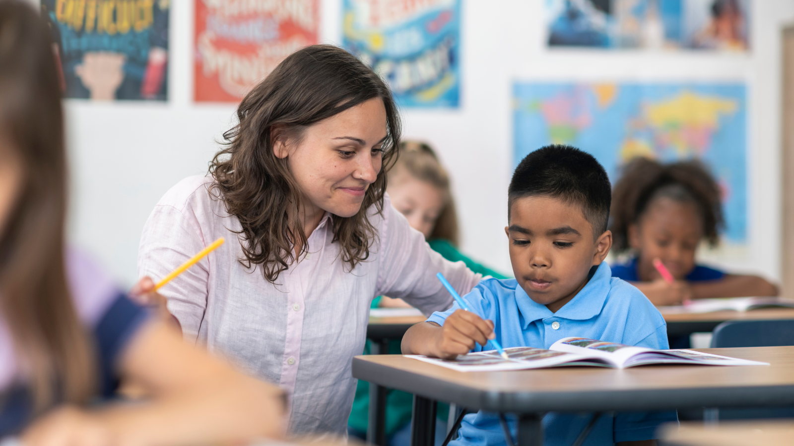Photo of a teacher instructing a student in a classroom